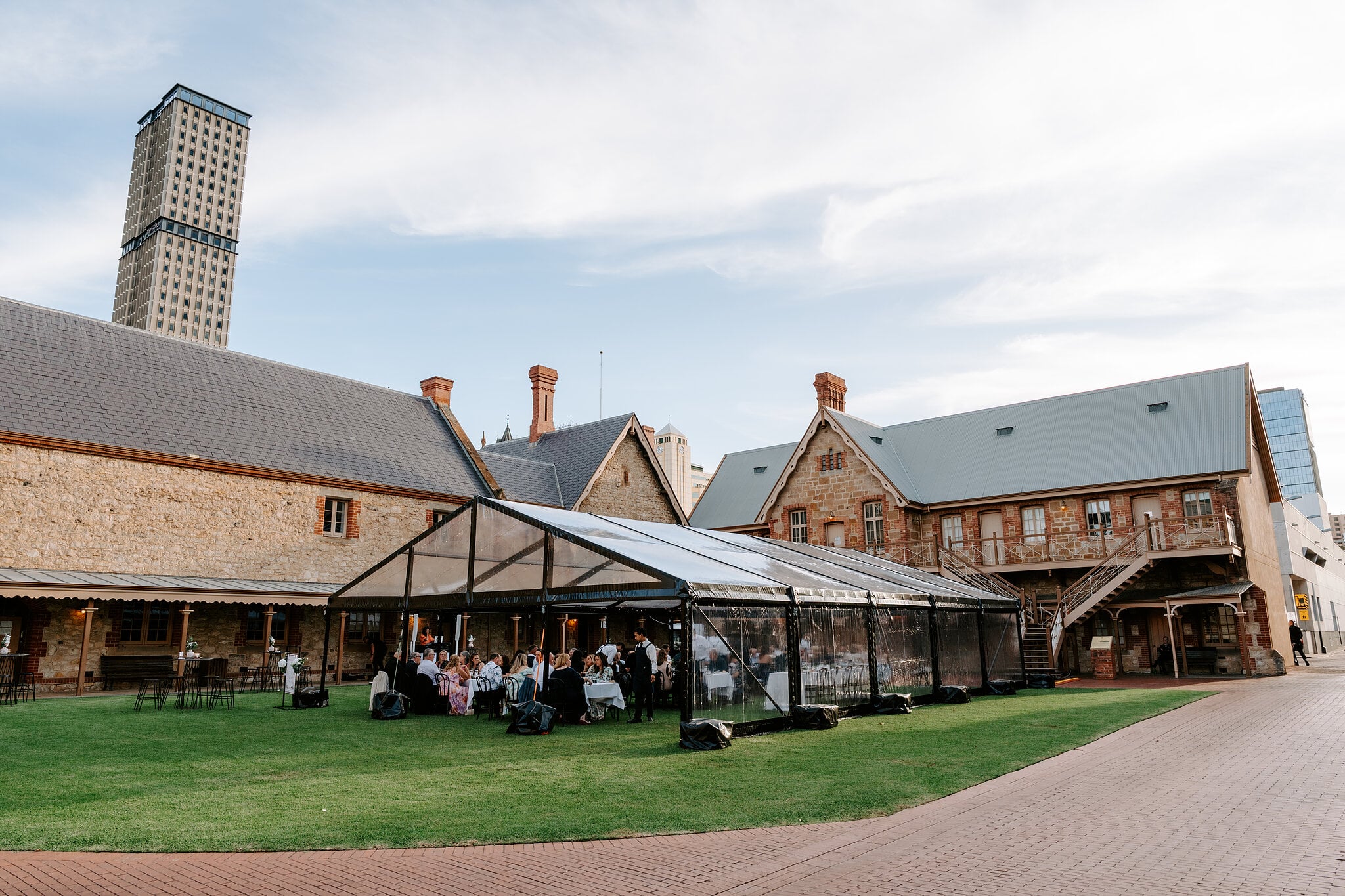 A clear marquee stands on the lawn behind the South Australian Museum, its tables set for the reception.