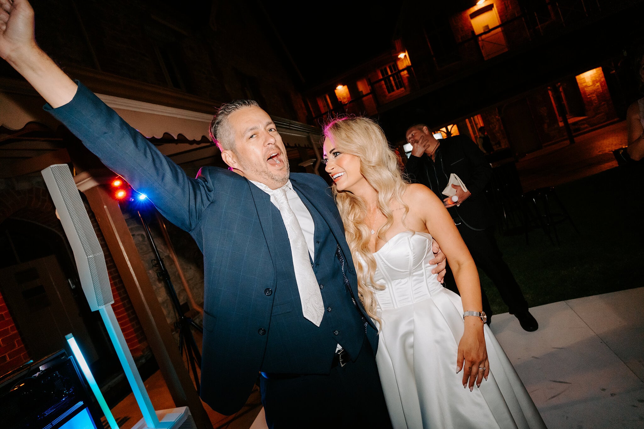 Joe punches the air beside Sarah on the dance floor.