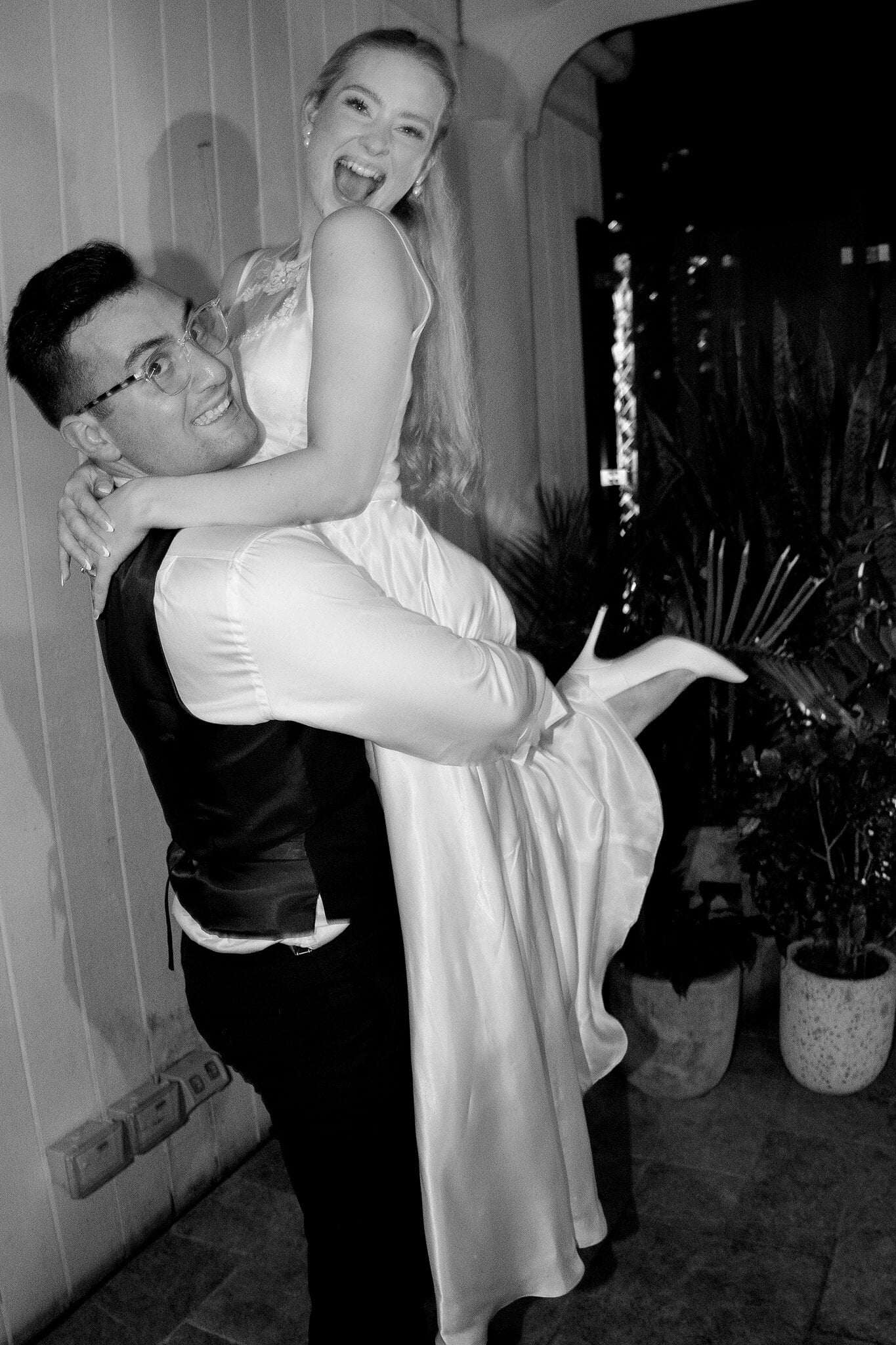 Jordan hoists Sorayaa up as she squeals with laughter in her second dress, in black and white.