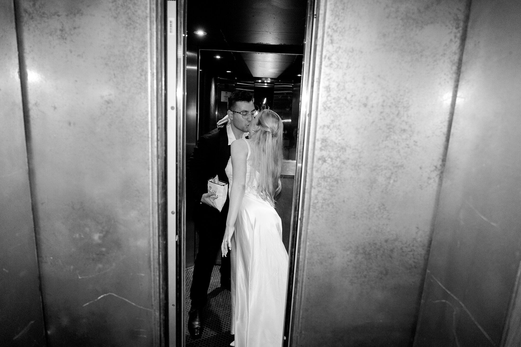 A kiss in the lift at the end of the night at The Island Gold Coast, in black and white.