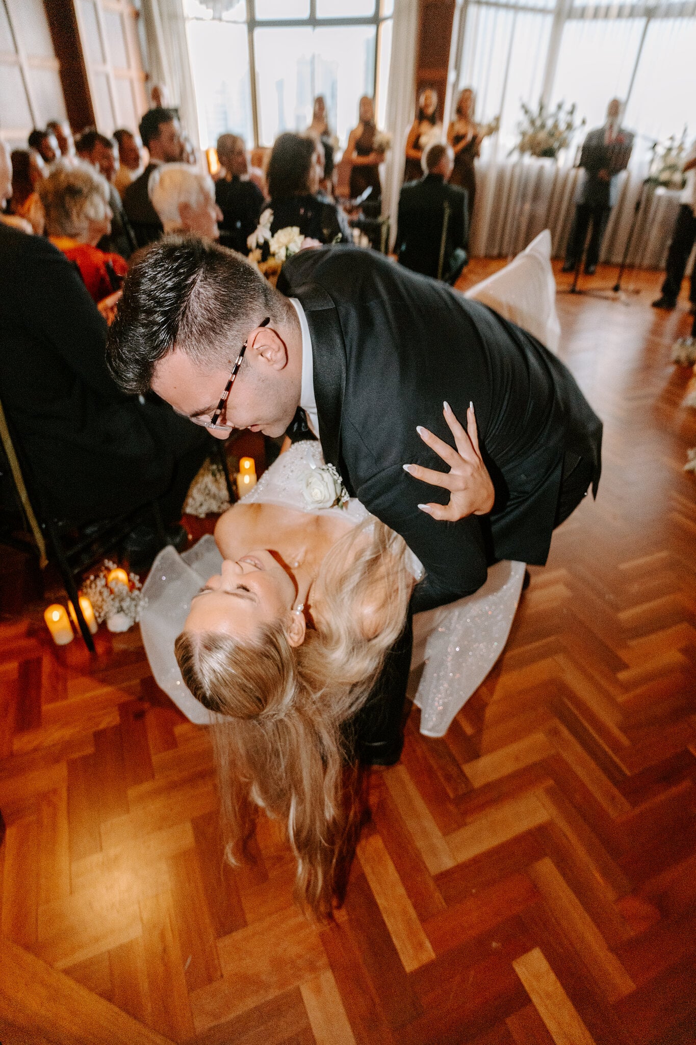 Jordan dips Sorayaa low on the parquet floor as guests cheer.