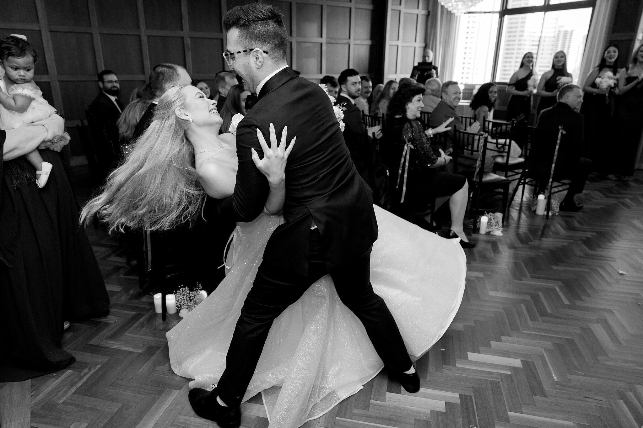 Sorayaa’s hair flies as Jordan dips her in the aisle, in black and white.